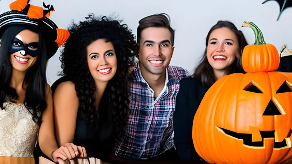 A group of people confidently posing in their homemade costumes at a Halloween party, attracting attention and admiration from others.